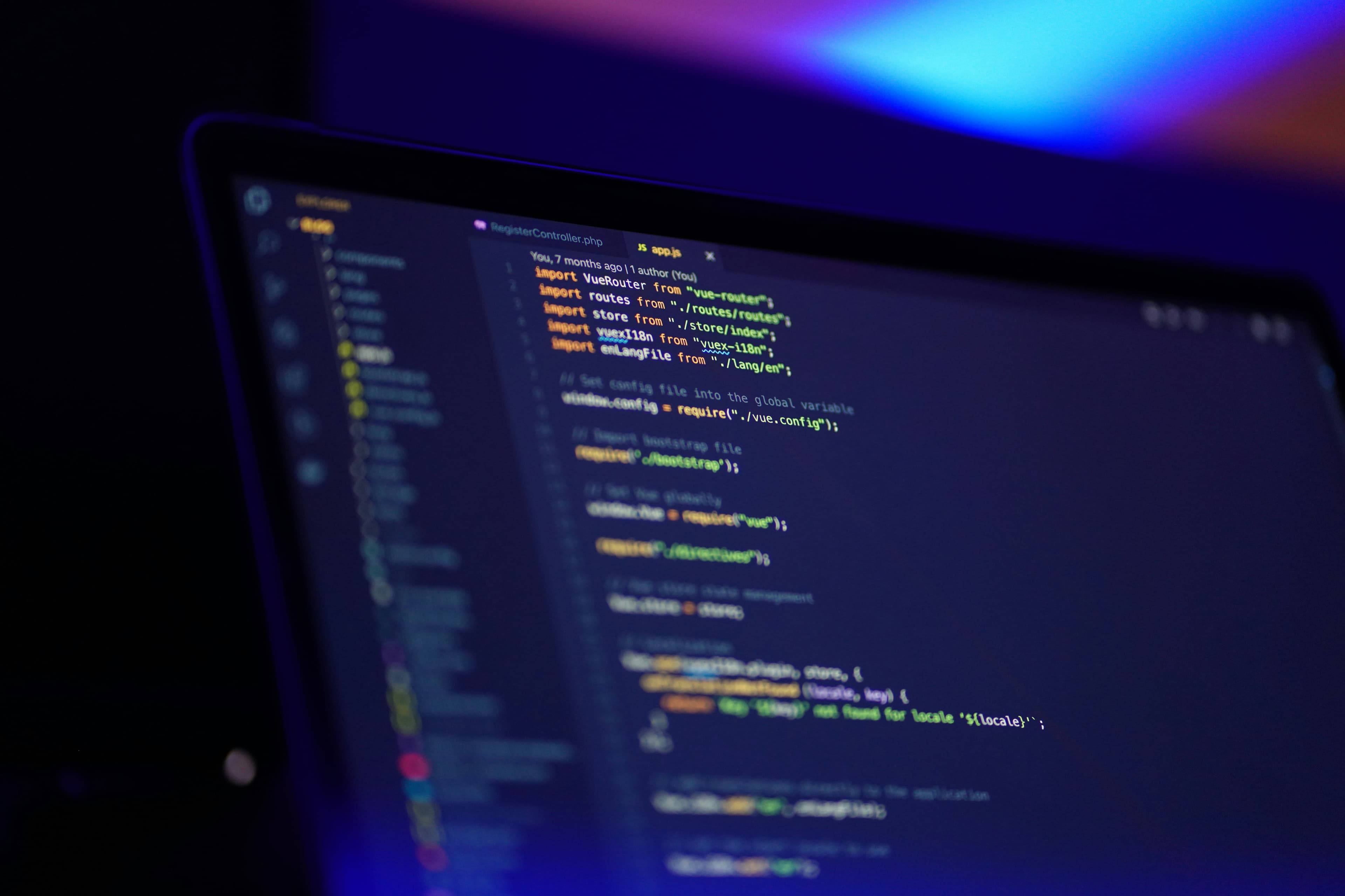 Close view of a laptop displaying application code in a dark editor