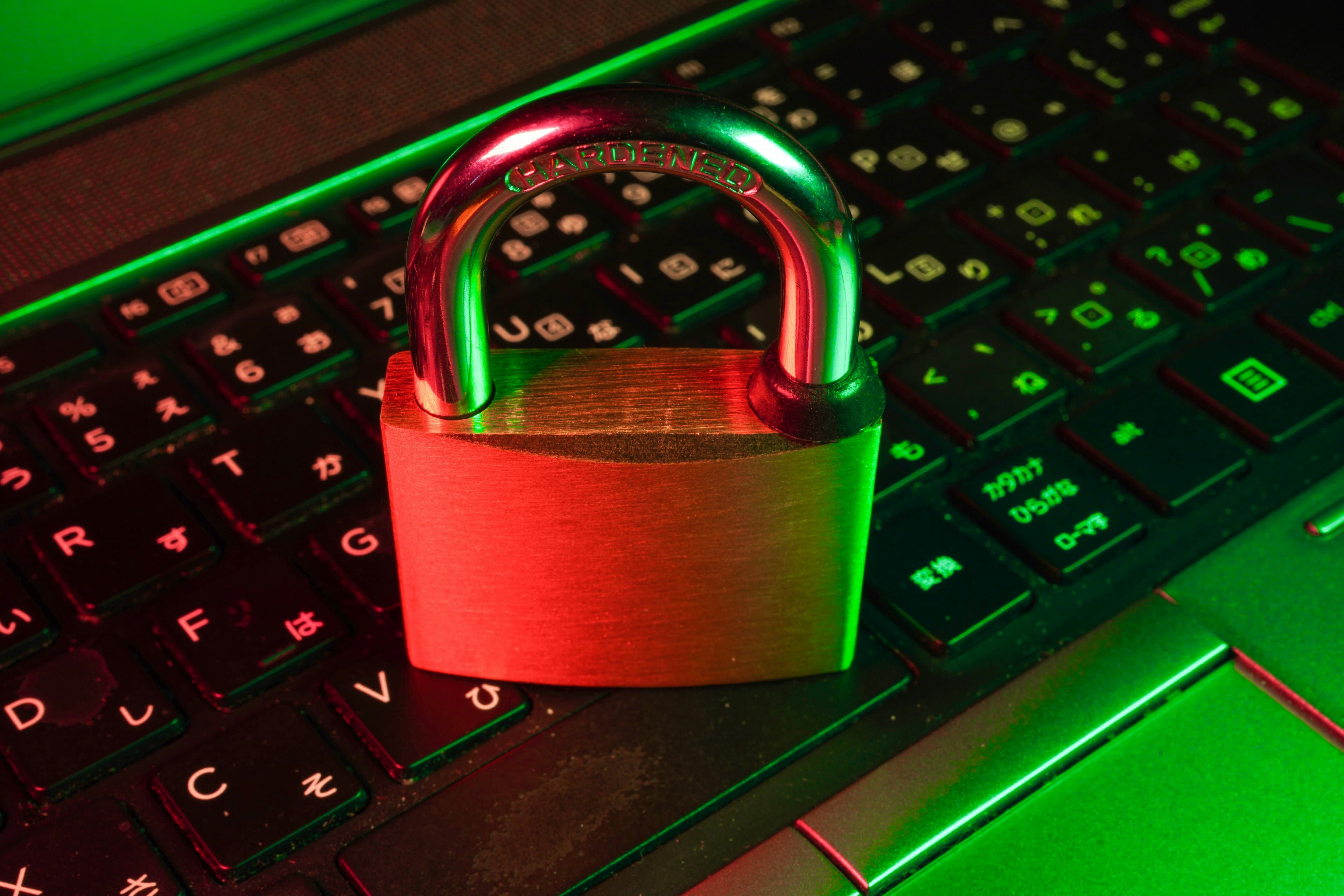 Padlock resting over a computer keyboard, illustrating controlled access to digital systems
