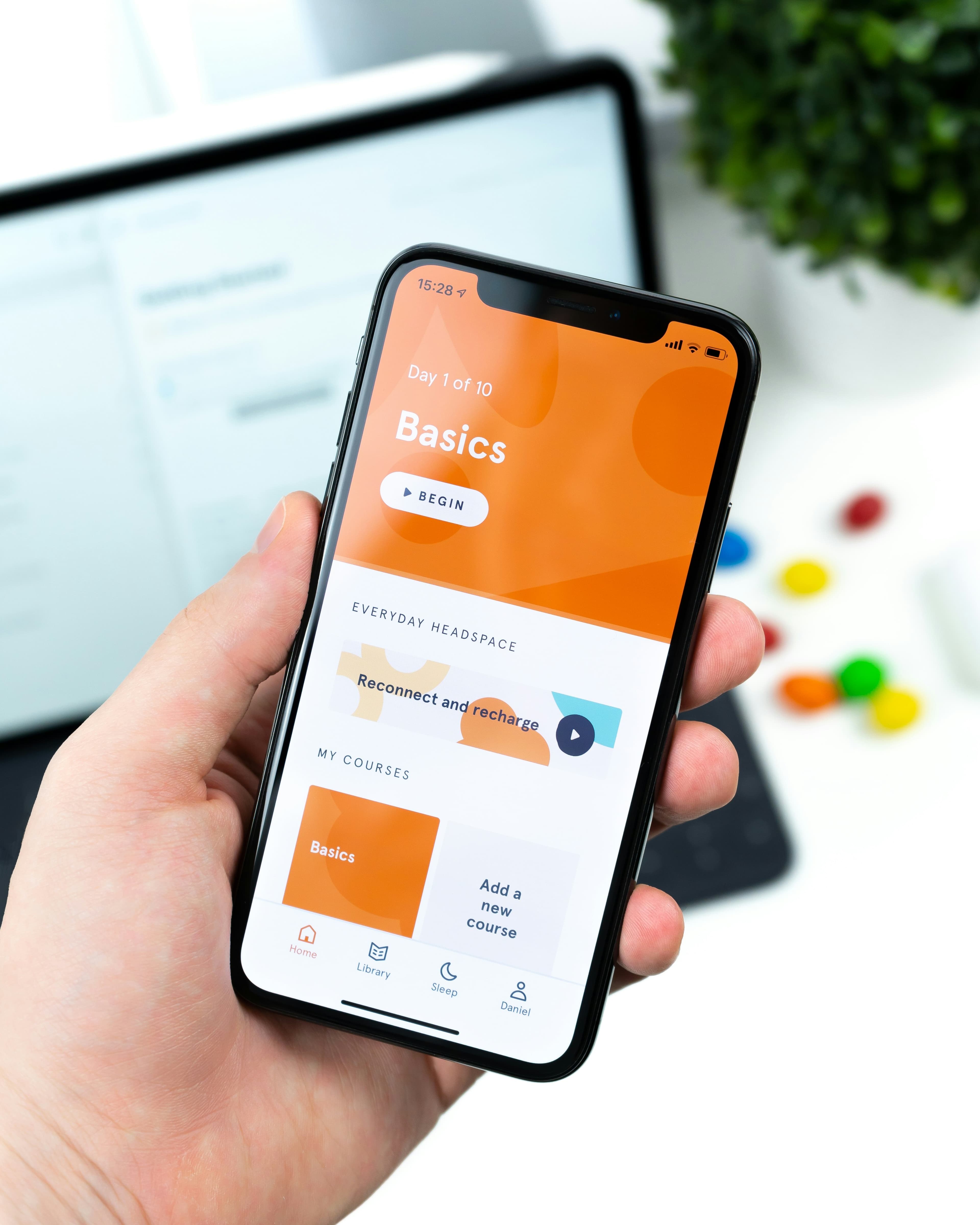 Hand holding a smartphone with a learning app open